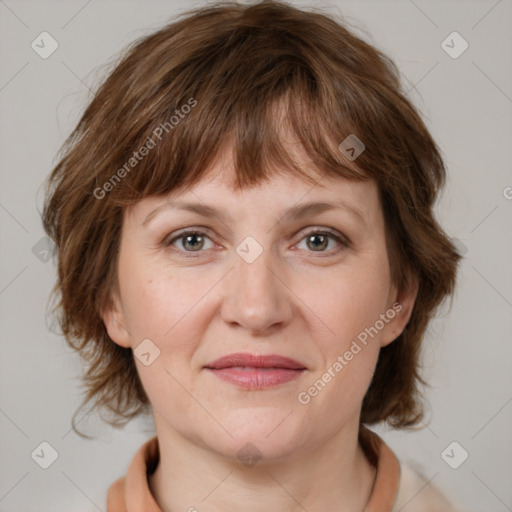 Joyful white adult female with medium  brown hair and grey eyes