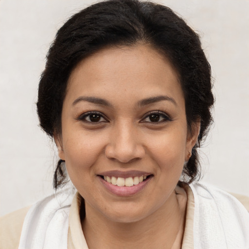 Joyful latino young-adult female with long  brown hair and brown eyes