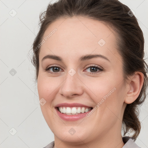 Joyful white young-adult female with medium  brown hair and grey eyes