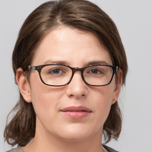 Joyful white young-adult female with medium  brown hair and blue eyes