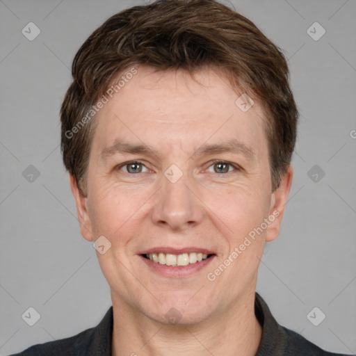 Joyful white adult male with short  brown hair and grey eyes