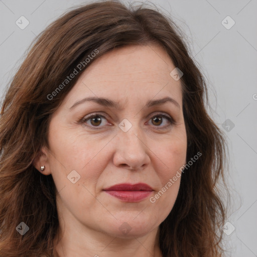 Joyful white adult female with long  brown hair and brown eyes