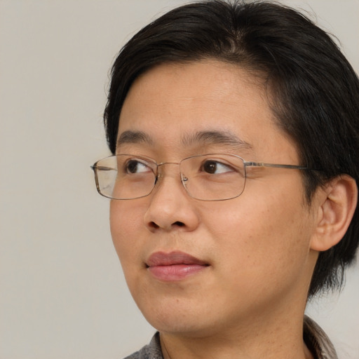 Joyful asian adult male with short  brown hair and brown eyes