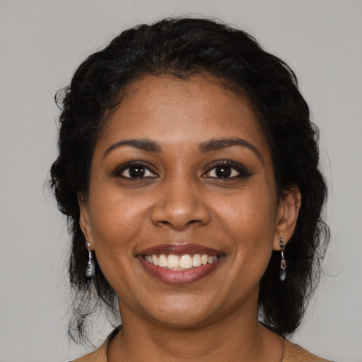 Joyful black young-adult female with medium  black hair and brown eyes
