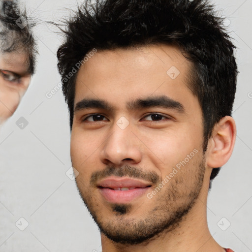 Joyful white young-adult male with short  black hair and brown eyes