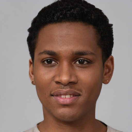 Joyful black young-adult male with short  brown hair and brown eyes