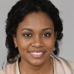 Joyful black young-adult female with medium  brown hair and brown eyes