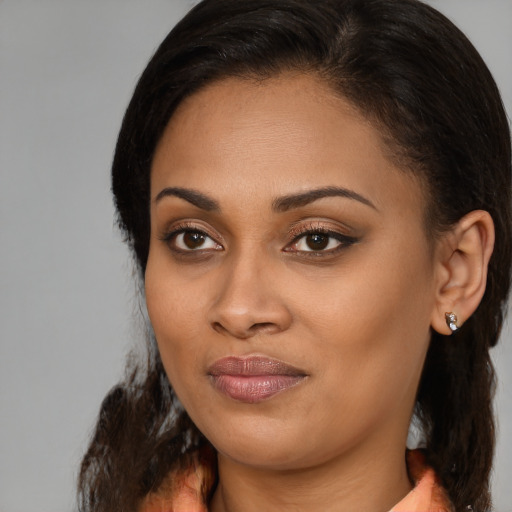 Joyful black young-adult female with medium  brown hair and brown eyes
