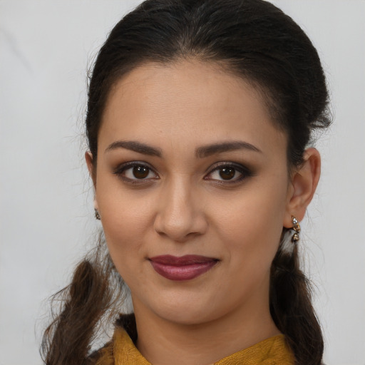 Joyful latino young-adult female with long  brown hair and brown eyes
