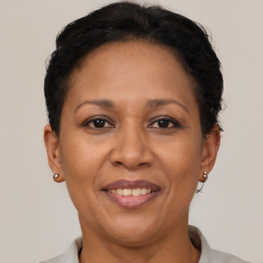 Joyful latino adult female with short  brown hair and brown eyes