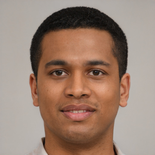 Joyful latino young-adult male with short  brown hair and brown eyes