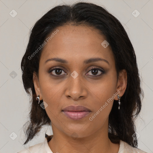 Joyful black adult female with medium  brown hair and brown eyes