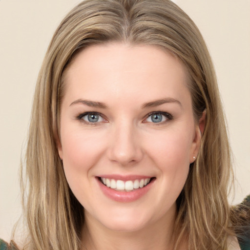 Joyful white young-adult female with long  brown hair and grey eyes