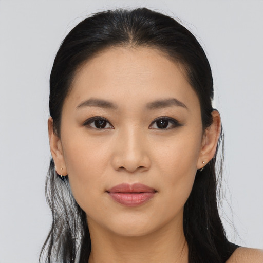Joyful asian young-adult female with long  brown hair and brown eyes