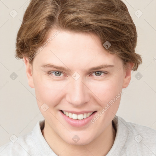 Joyful white young-adult female with short  brown hair and blue eyes