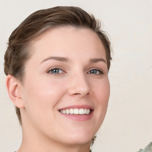 Joyful white young-adult female with short  brown hair and grey eyes