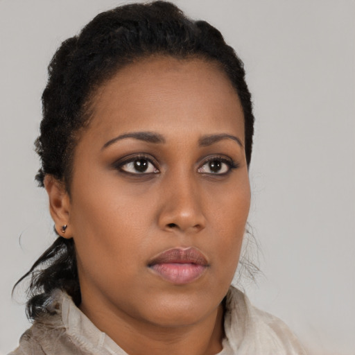 Neutral black young-adult female with medium  brown hair and brown eyes