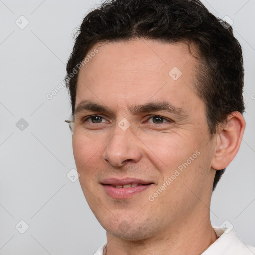 Joyful white adult male with short  brown hair and brown eyes