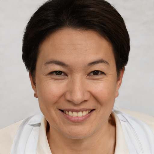 Joyful white adult female with short  brown hair and brown eyes