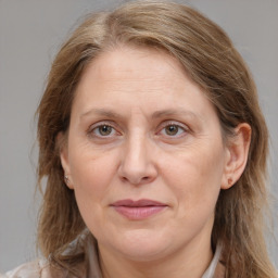 Joyful white adult female with medium  brown hair and grey eyes