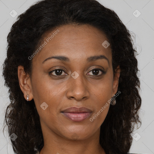 Joyful black young-adult female with long  brown hair and brown eyes