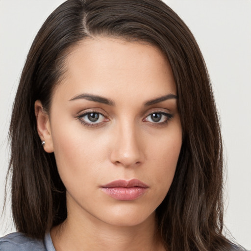 Neutral white young-adult female with long  brown hair and brown eyes