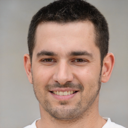 Joyful white young-adult male with short  brown hair and brown eyes