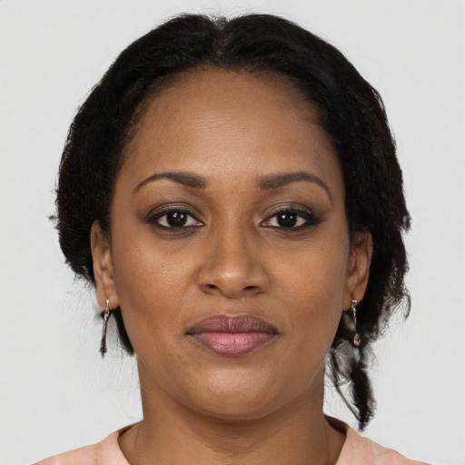 Joyful black adult female with medium  black hair and brown eyes