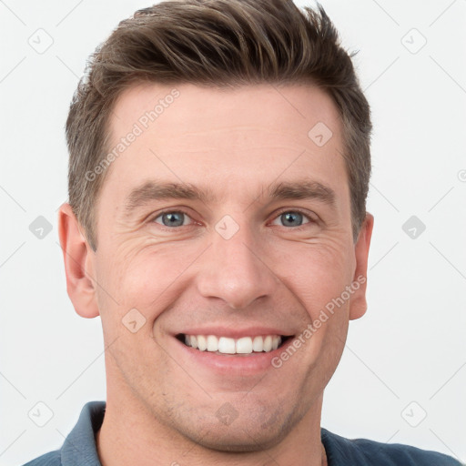 Joyful white young-adult male with short  brown hair and grey eyes