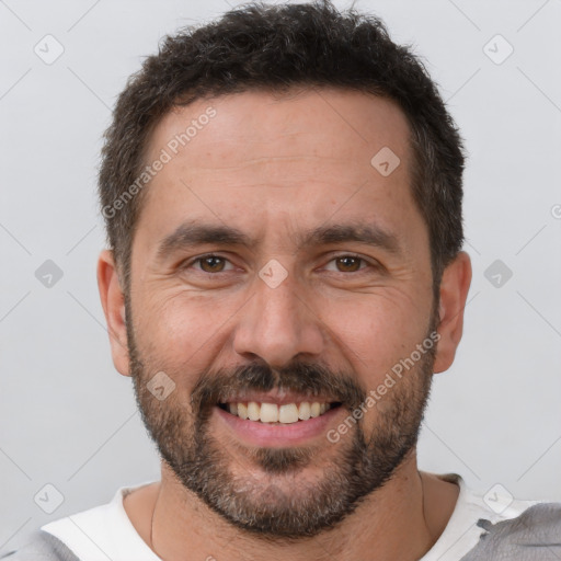 Joyful white adult male with short  brown hair and brown eyes