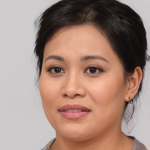 Joyful asian young-adult female with medium  brown hair and brown eyes