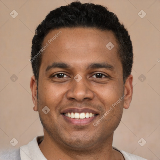 Joyful latino young-adult male with short  black hair and brown eyes