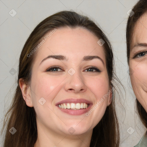 Joyful white young-adult female with long  brown hair and grey eyes