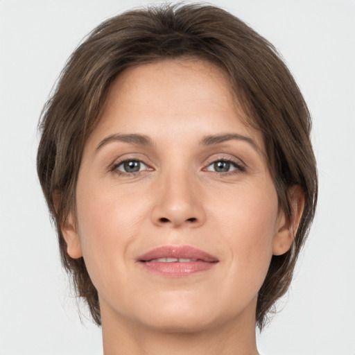 Joyful white adult female with medium  brown hair and brown eyes