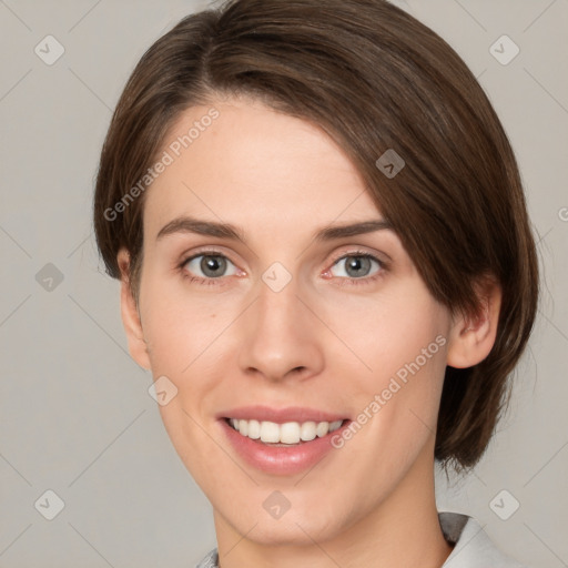 Joyful white young-adult female with medium  brown hair and green eyes