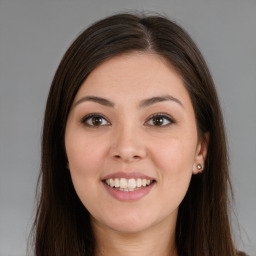 Joyful latino young-adult female with long  brown hair and brown eyes