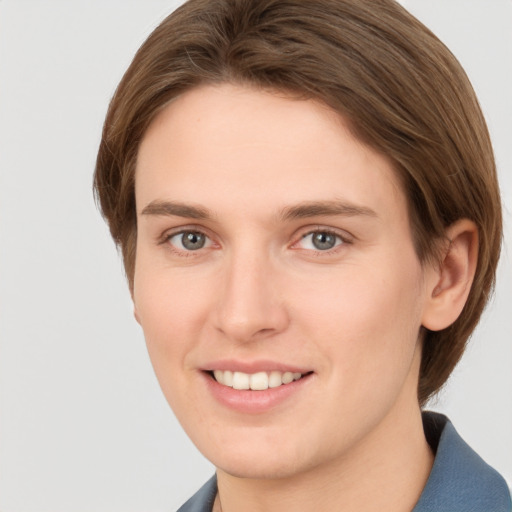 Joyful white young-adult female with short  brown hair and grey eyes