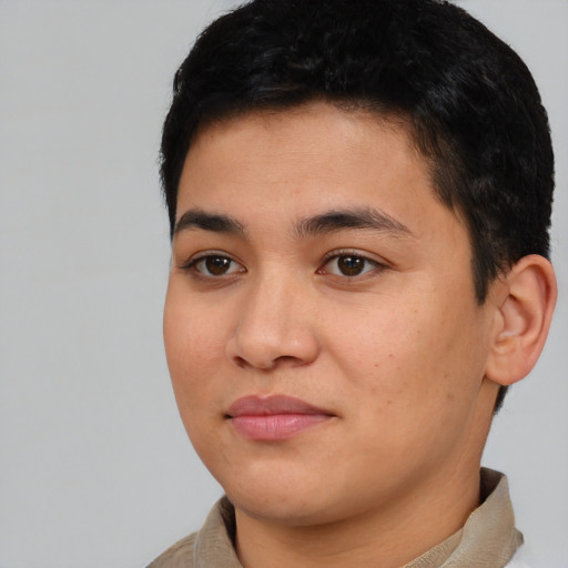 Joyful latino young-adult male with short  black hair and brown eyes