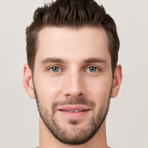 Joyful white young-adult male with short  brown hair and brown eyes