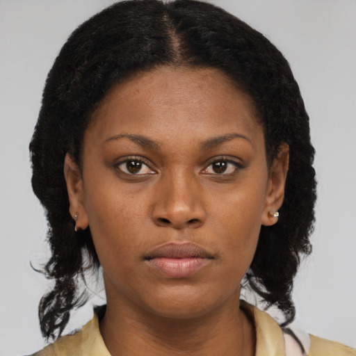 Neutral black young-adult female with medium  brown hair and brown eyes