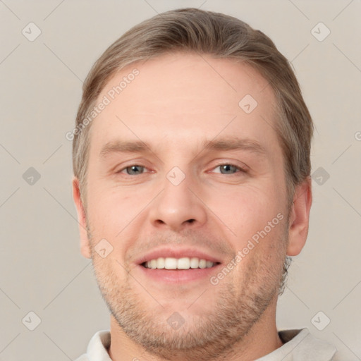 Joyful white adult male with short  brown hair and grey eyes