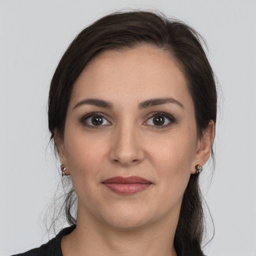 Joyful white young-adult female with medium  brown hair and brown eyes