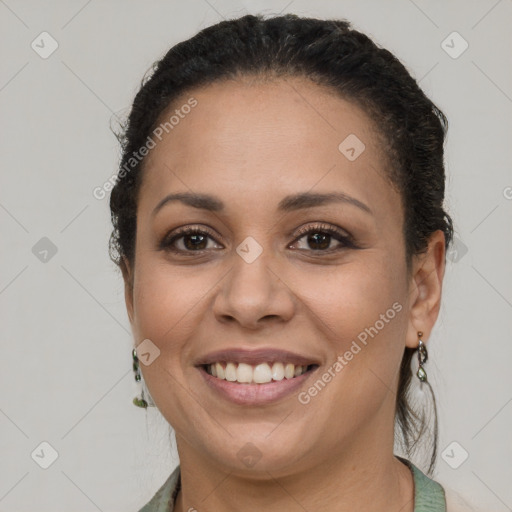 Joyful latino young-adult female with short  brown hair and brown eyes