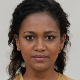 Joyful black young-adult female with medium  brown hair and brown eyes