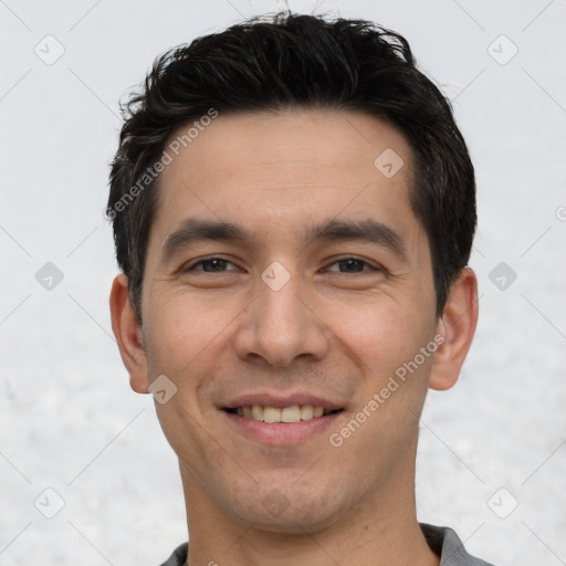 Joyful white young-adult male with short  black hair and brown eyes