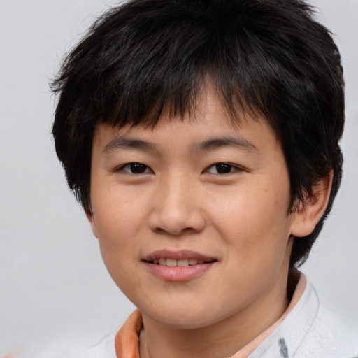 Joyful asian young-adult female with short  brown hair and brown eyes