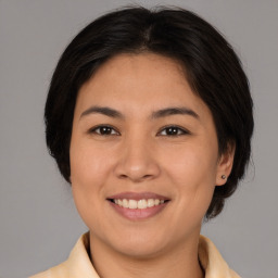 Joyful white young-adult female with medium  brown hair and brown eyes