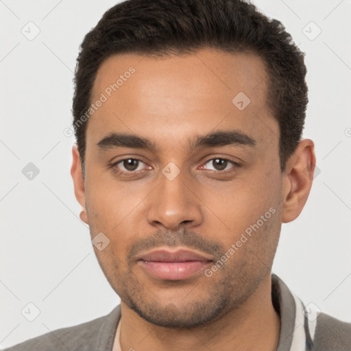 Joyful black young-adult male with short  brown hair and brown eyes