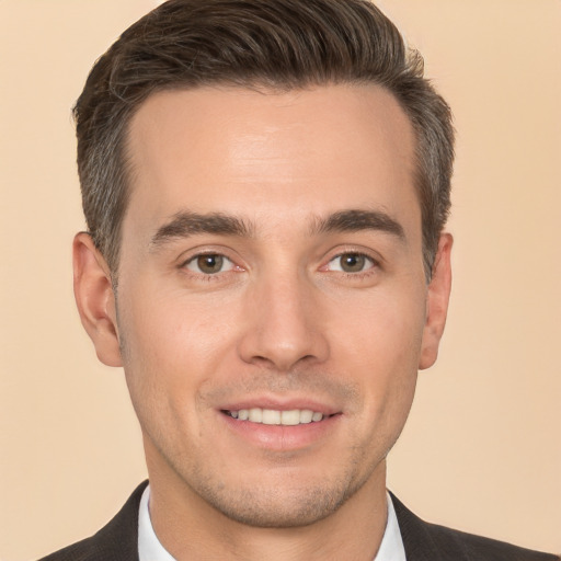 Joyful white young-adult male with short  brown hair and brown eyes