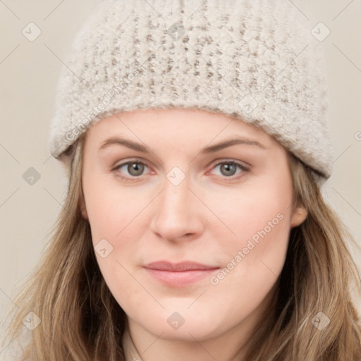 Joyful white young-adult female with long  brown hair and green eyes